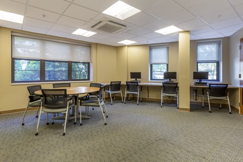 A conference room with a table and chairs.
